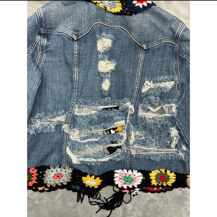Distressed vintage denim jacket with colorful crochet detailing
