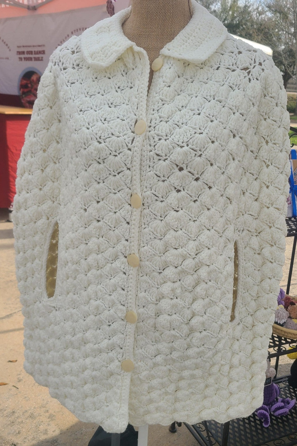 White textured jacket on a mannequin with outdoor background