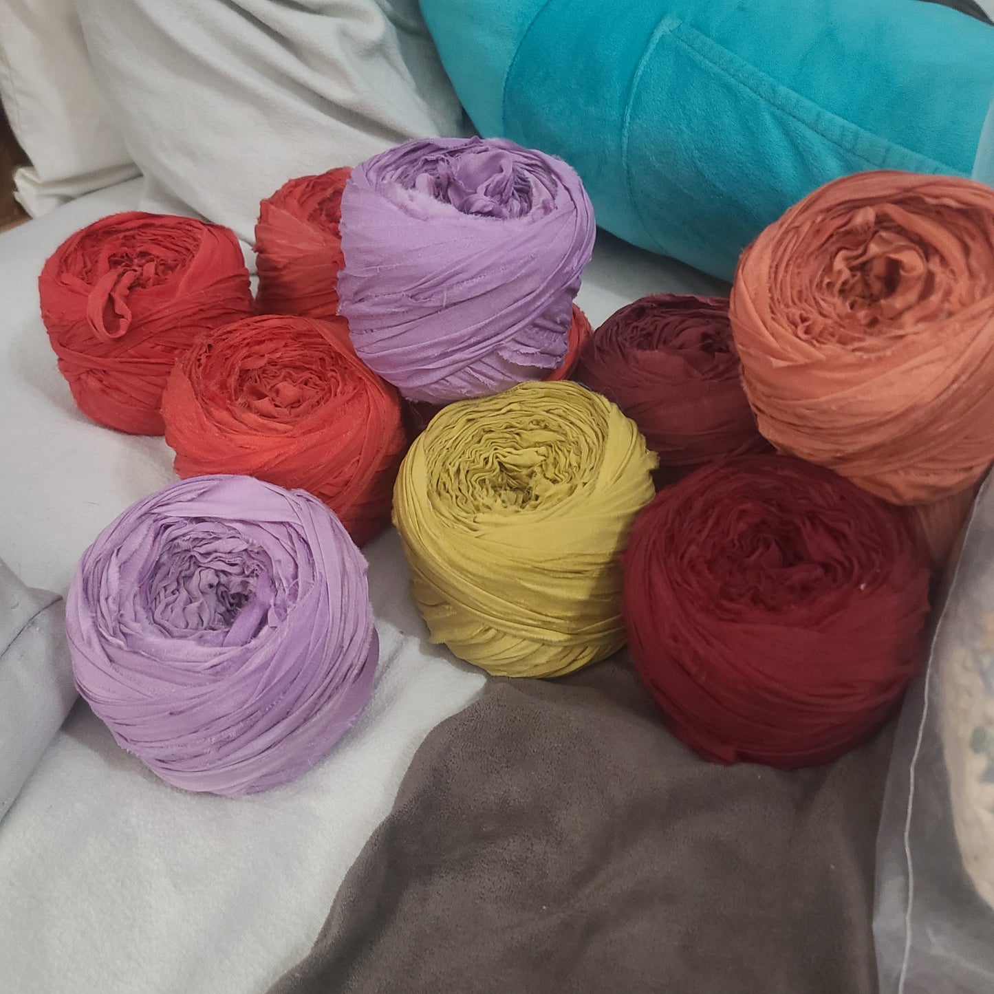 Colorful yarn balls on a textured fabric background