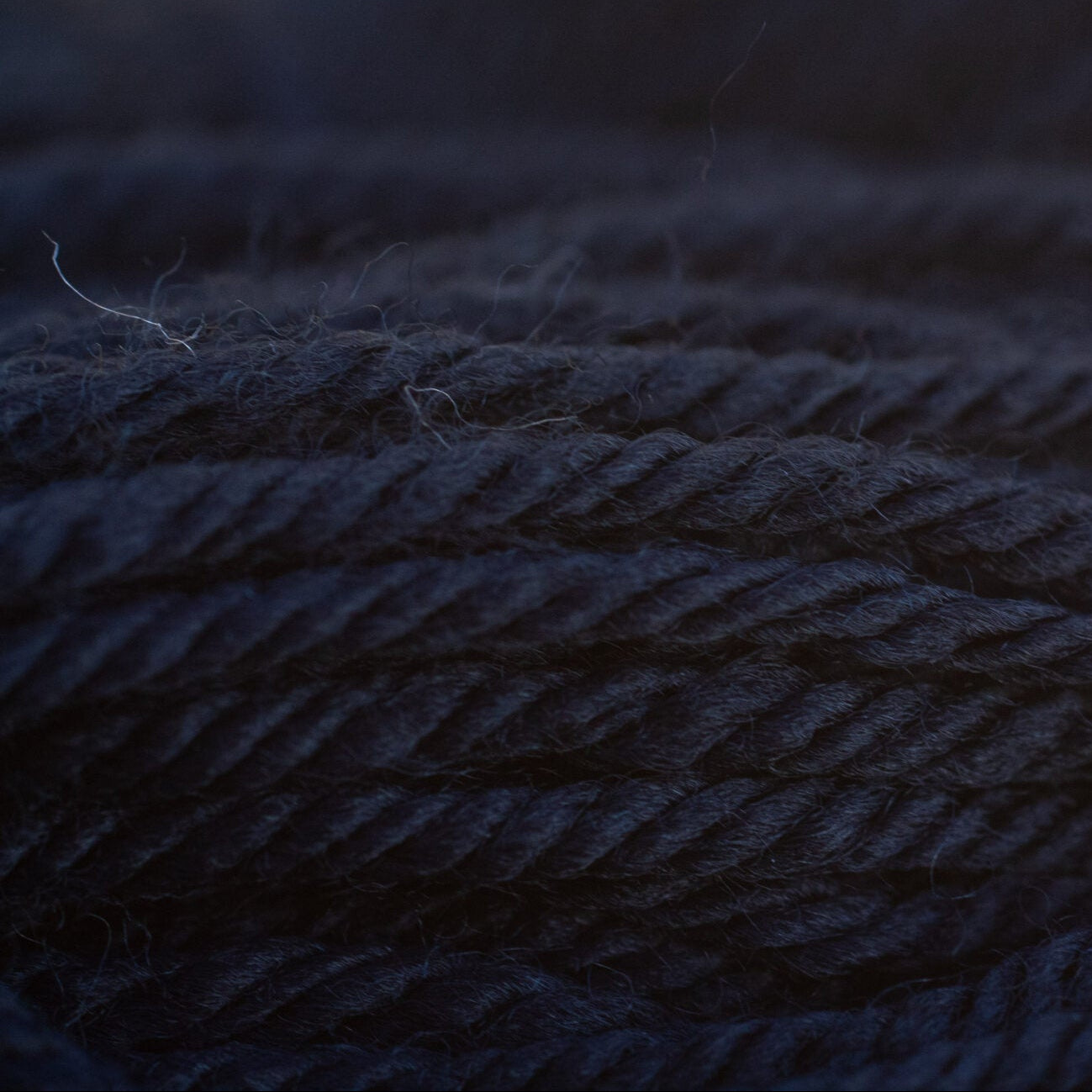 Close-up of black yarn with a blurred background