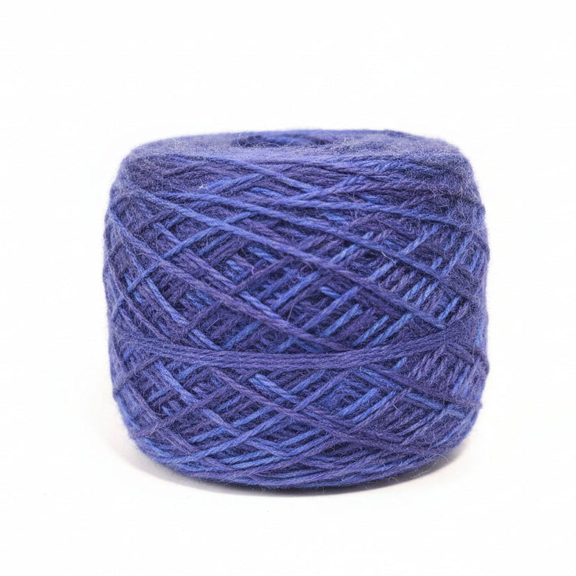 Blue yarn ball on a gray textured background