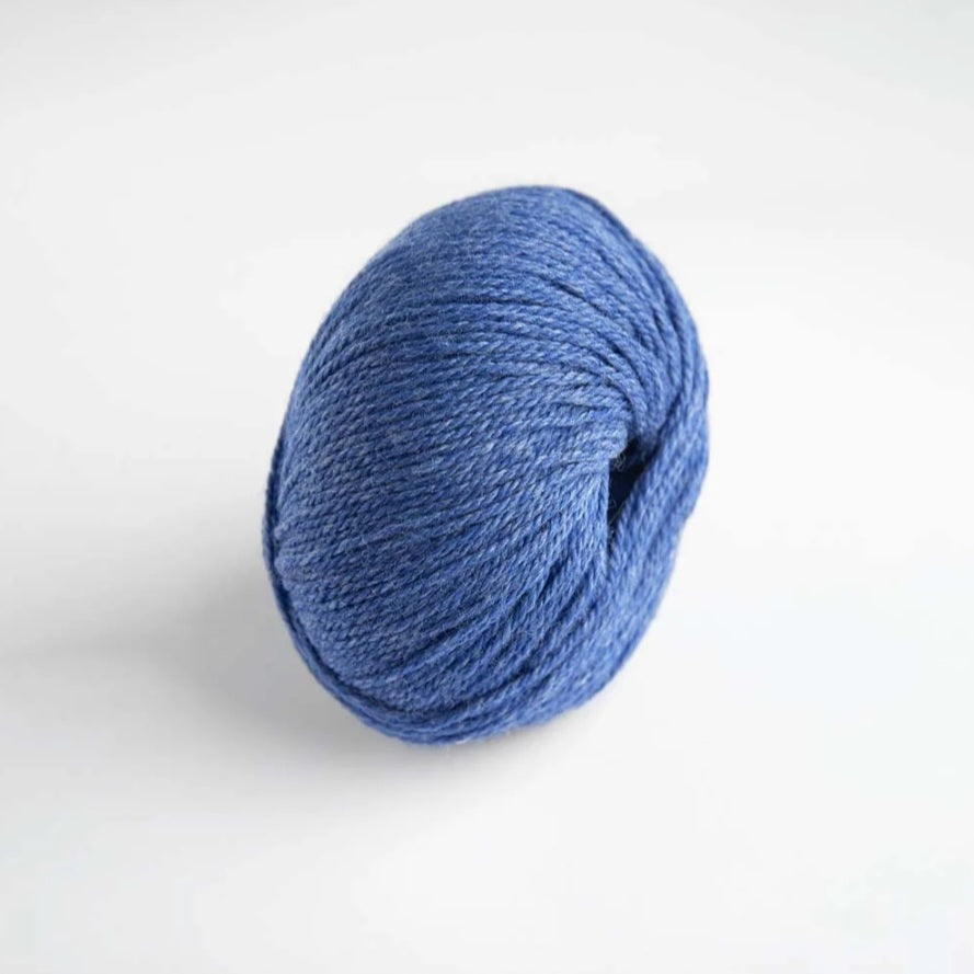 Blue skein of yarn on a white background
