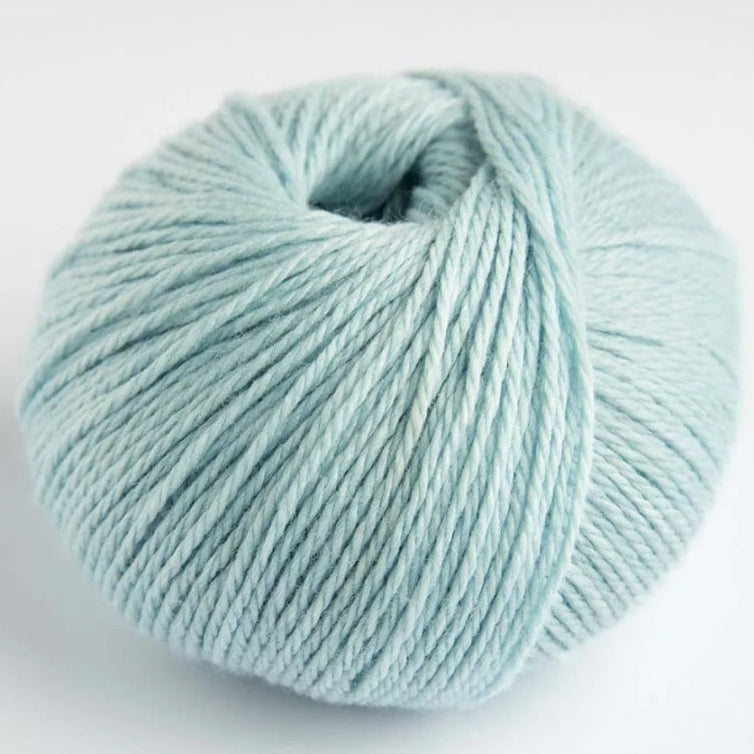 Light blue skein of yarn on a white background