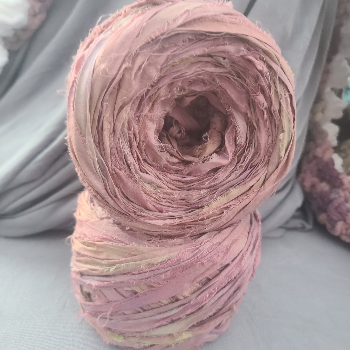 Pink yarn ball on a gray surface
