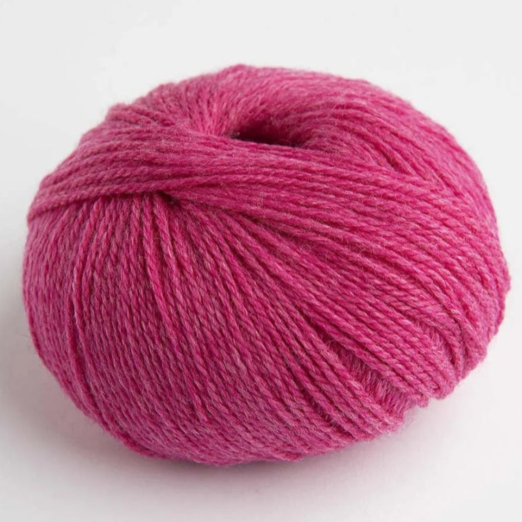 Pink skein of yarn on a white background