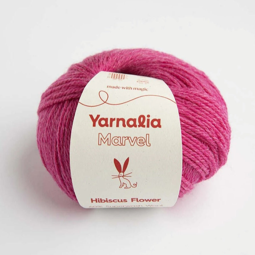 Pink yarn ball with 'Yarnalia Marvel' label on a white background