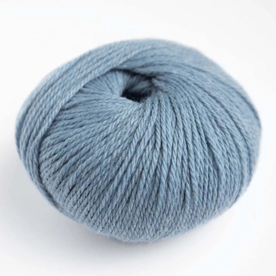 Blue skein of yarn on a white background