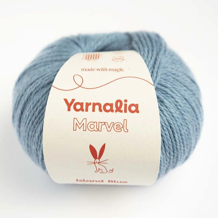 Ball of yarn with 'Yarnalia Marvel' label on a white background