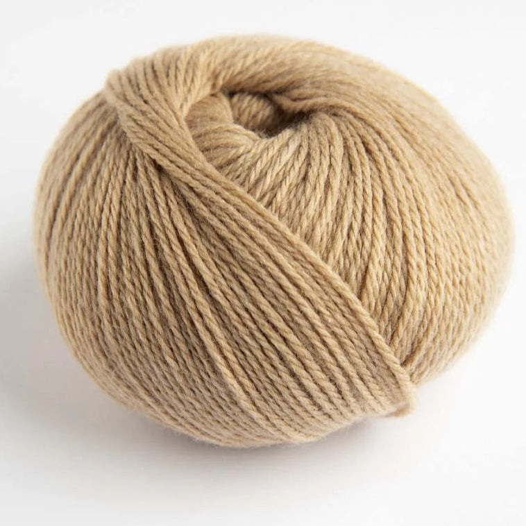Beige skein of yarn on a white background