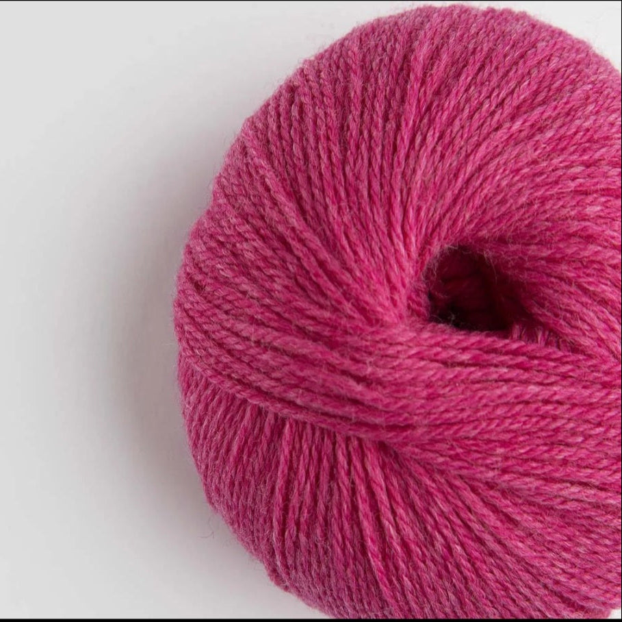 Ball of pink yarn on a white background