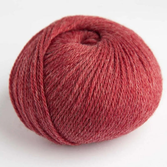 Red skein of yarn on a white background