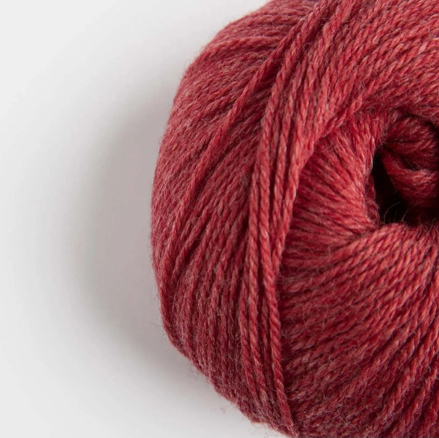 Close-up of a ball of red yarn on a white background