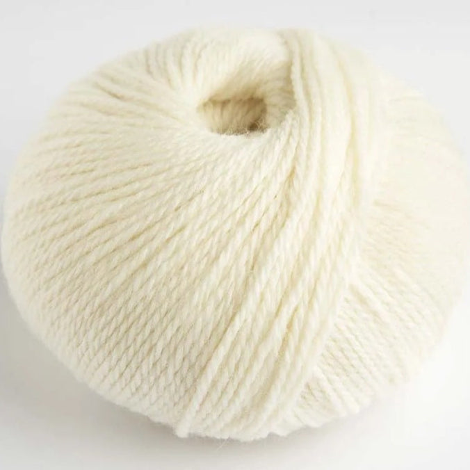 Ball of white yarn on a light gray background