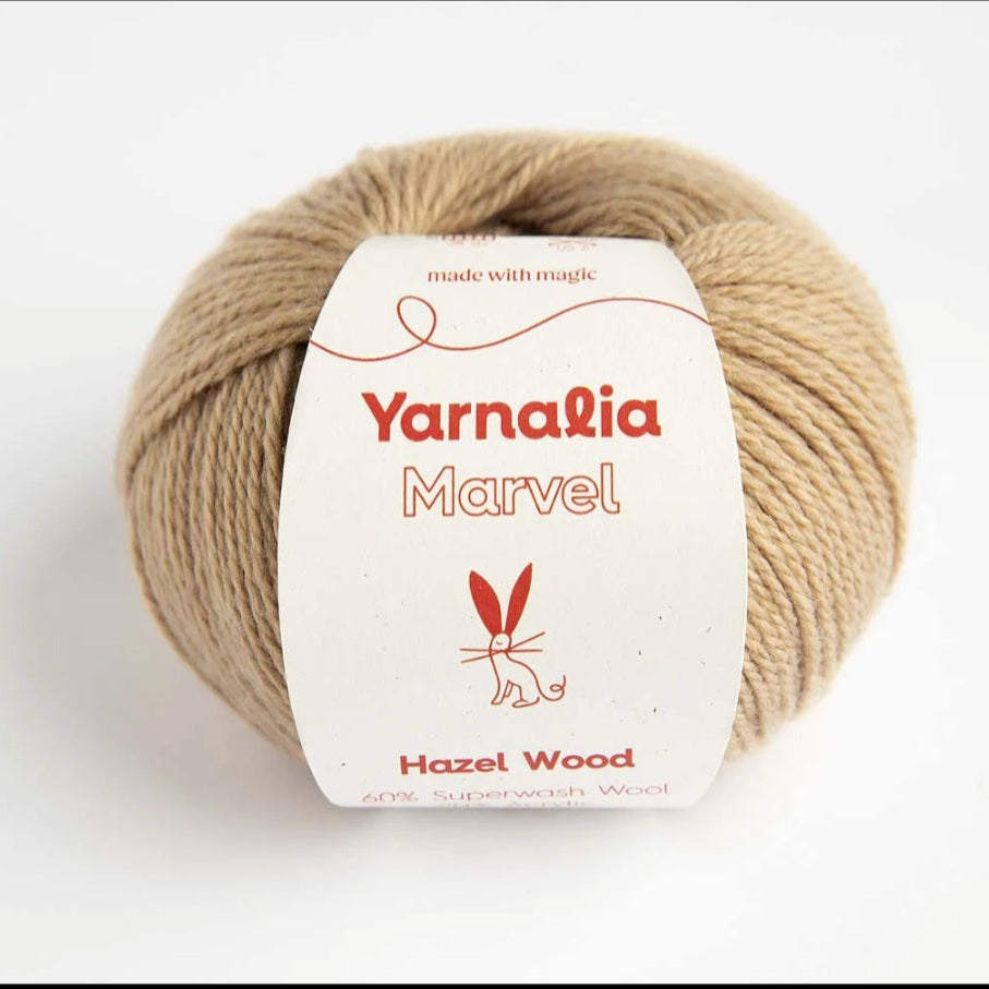 Ball of yarn with Yarnalia Marvel label on a white background