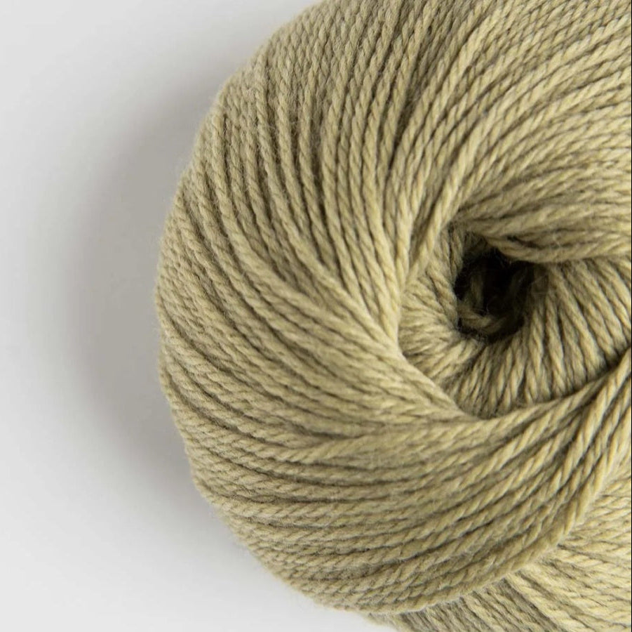 Ball of beige yarn on a white background