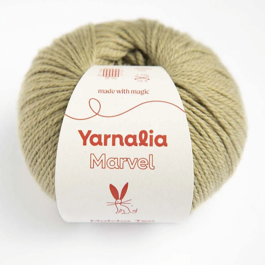 Ball of yarn with Yarnalia Marvel label on a white background