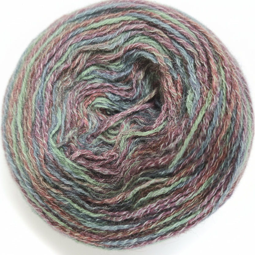 Multicolored yarn ball with shades of pink, green, and brown.