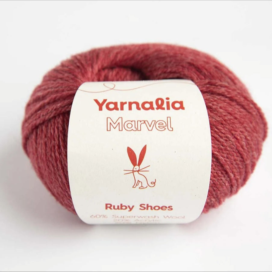 Red yarn ball with 'Yarnalia Marvel' label on a white background