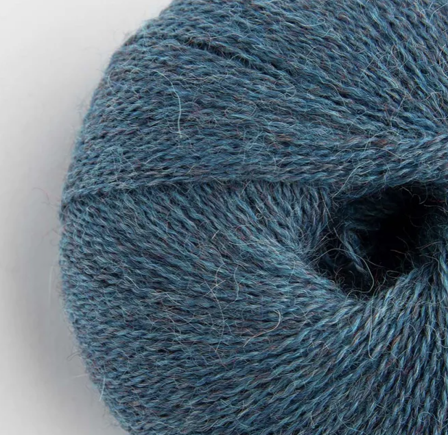 Close-up of a blue skein of yarn on a white background