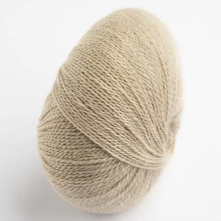 Ball of beige yarn on a white background