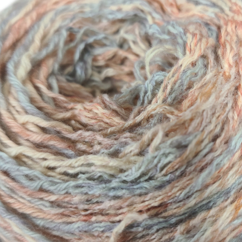 Close-up of multicolored yarn with shades of brown, gray, and beige.