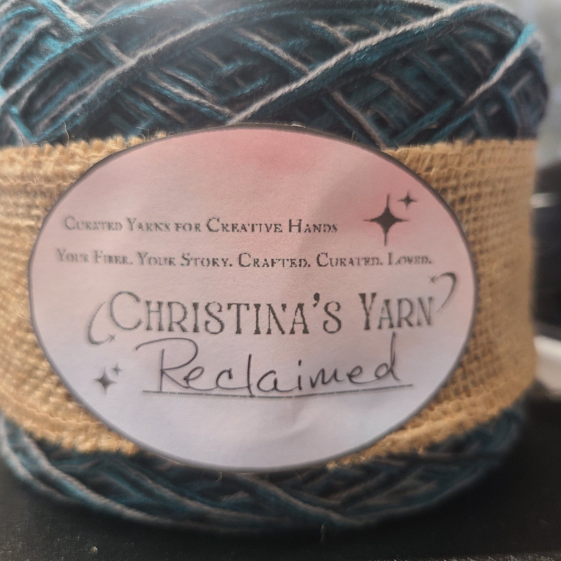Yarn ball with a label on a textured surface