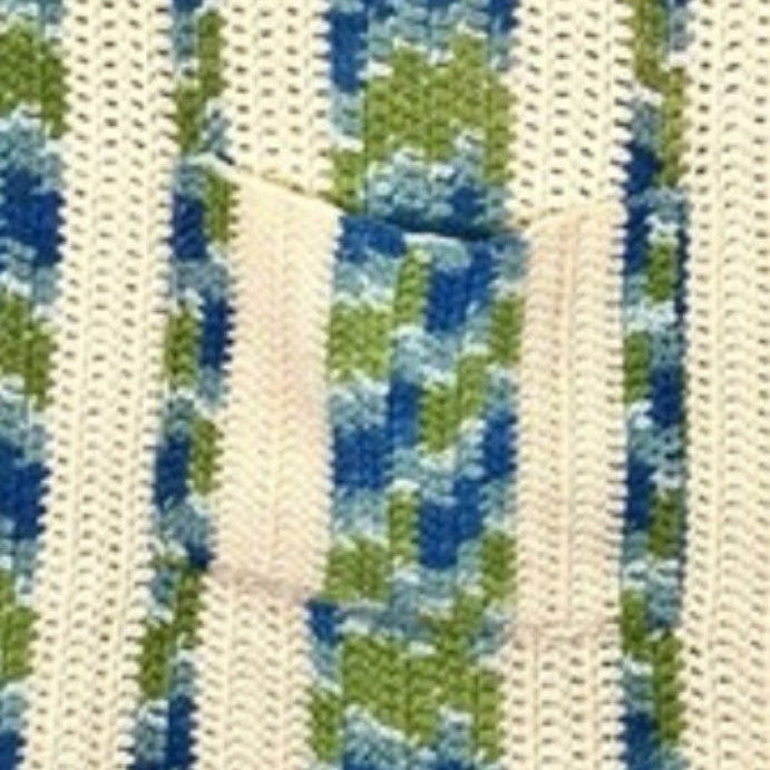 Close-up of a woven belt with blue, green, and beige pattern.