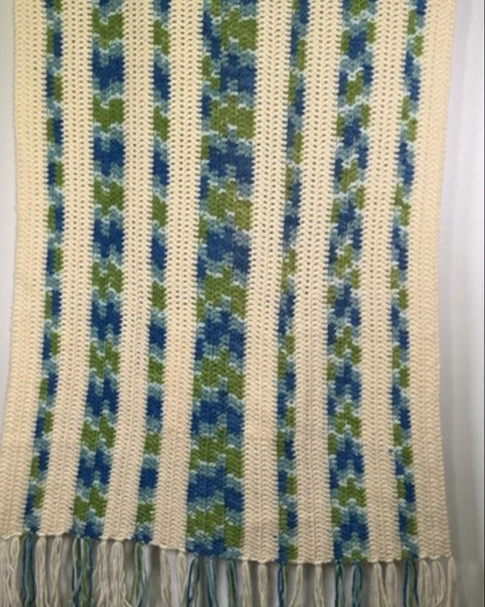 Textured fabric with blue and green pattern on a gray background