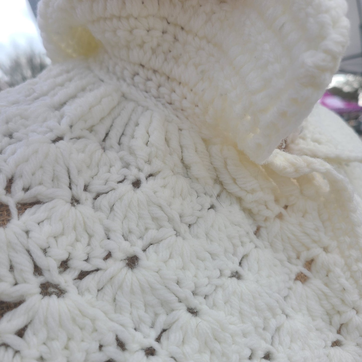 Close-up of a textured white fabric with a floral pattern