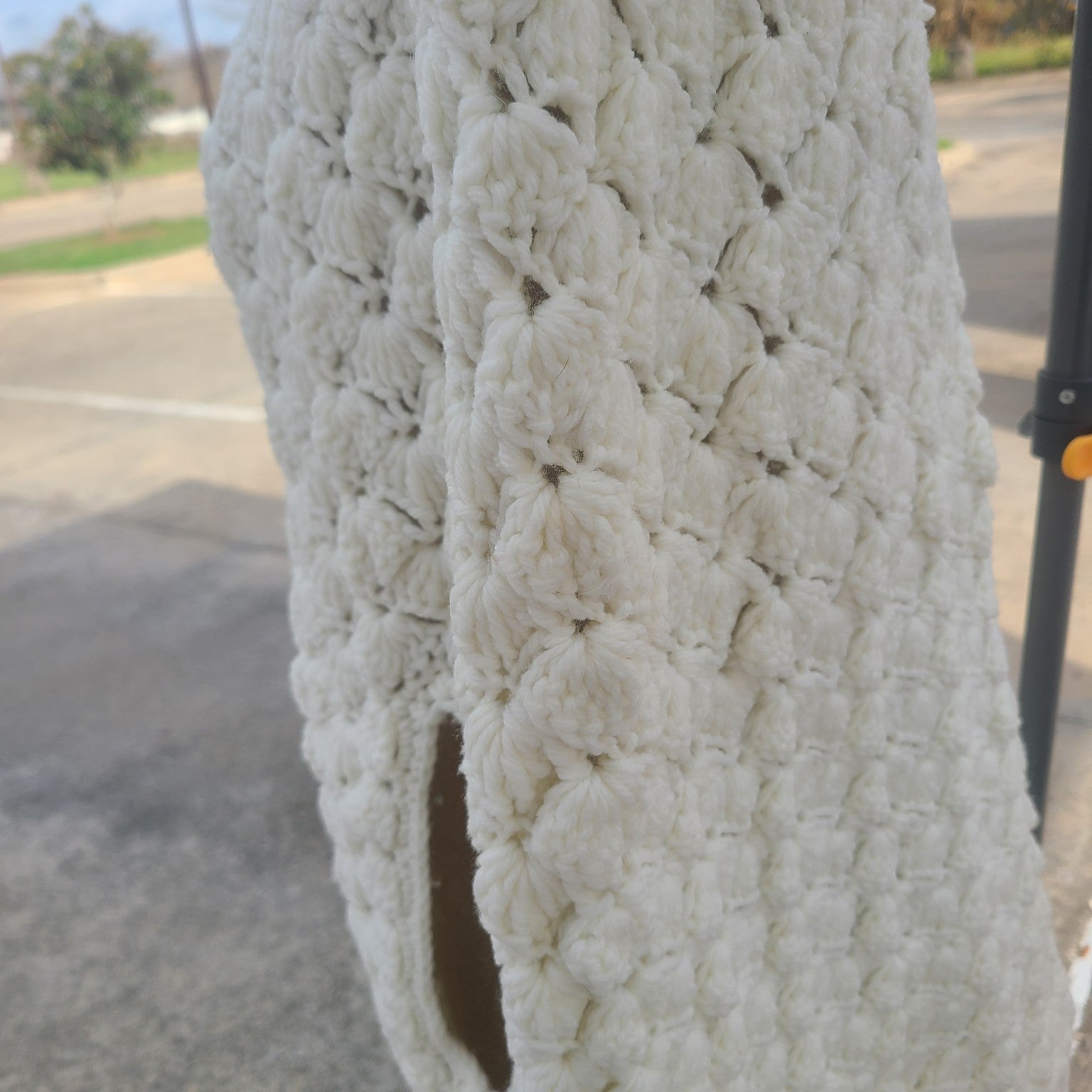 Close-up of a textured white object with a blurred outdoor background