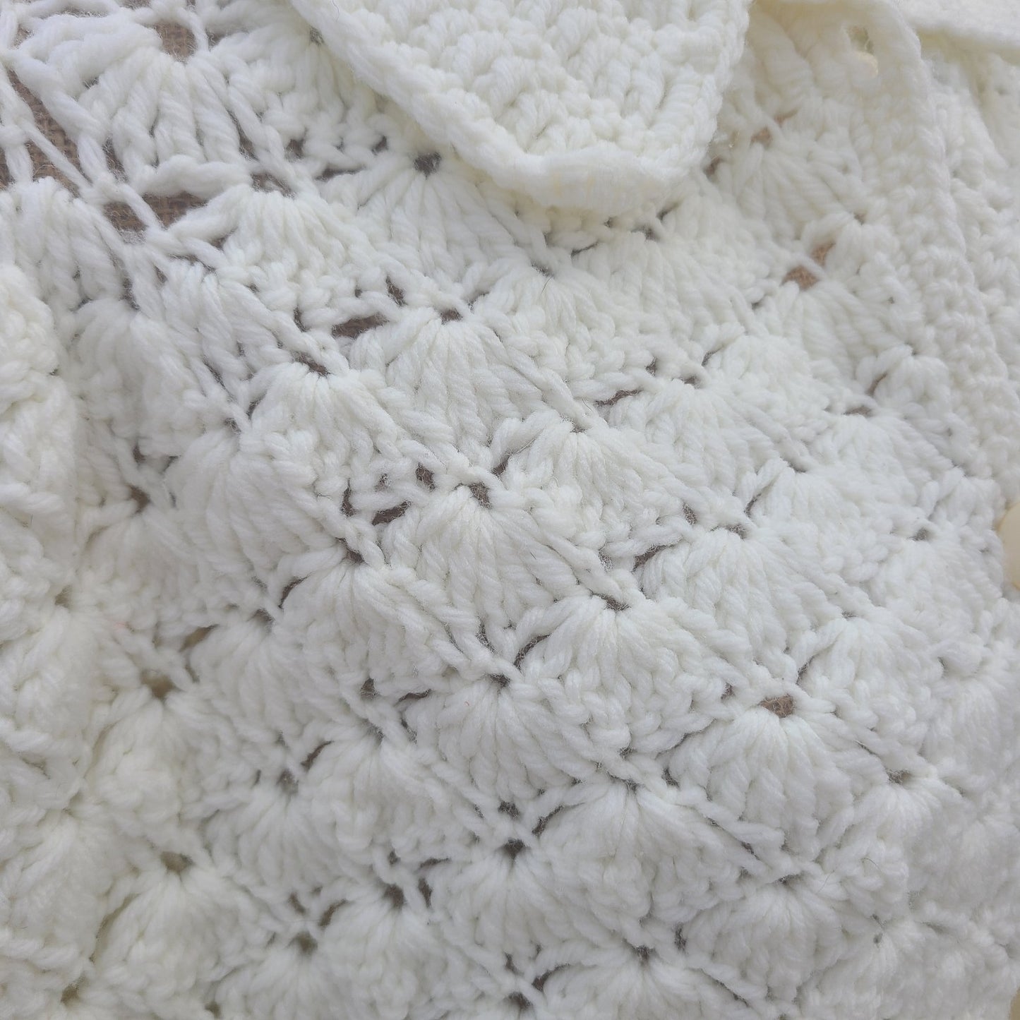 Close-up of a textured white fabric with a diamond pattern