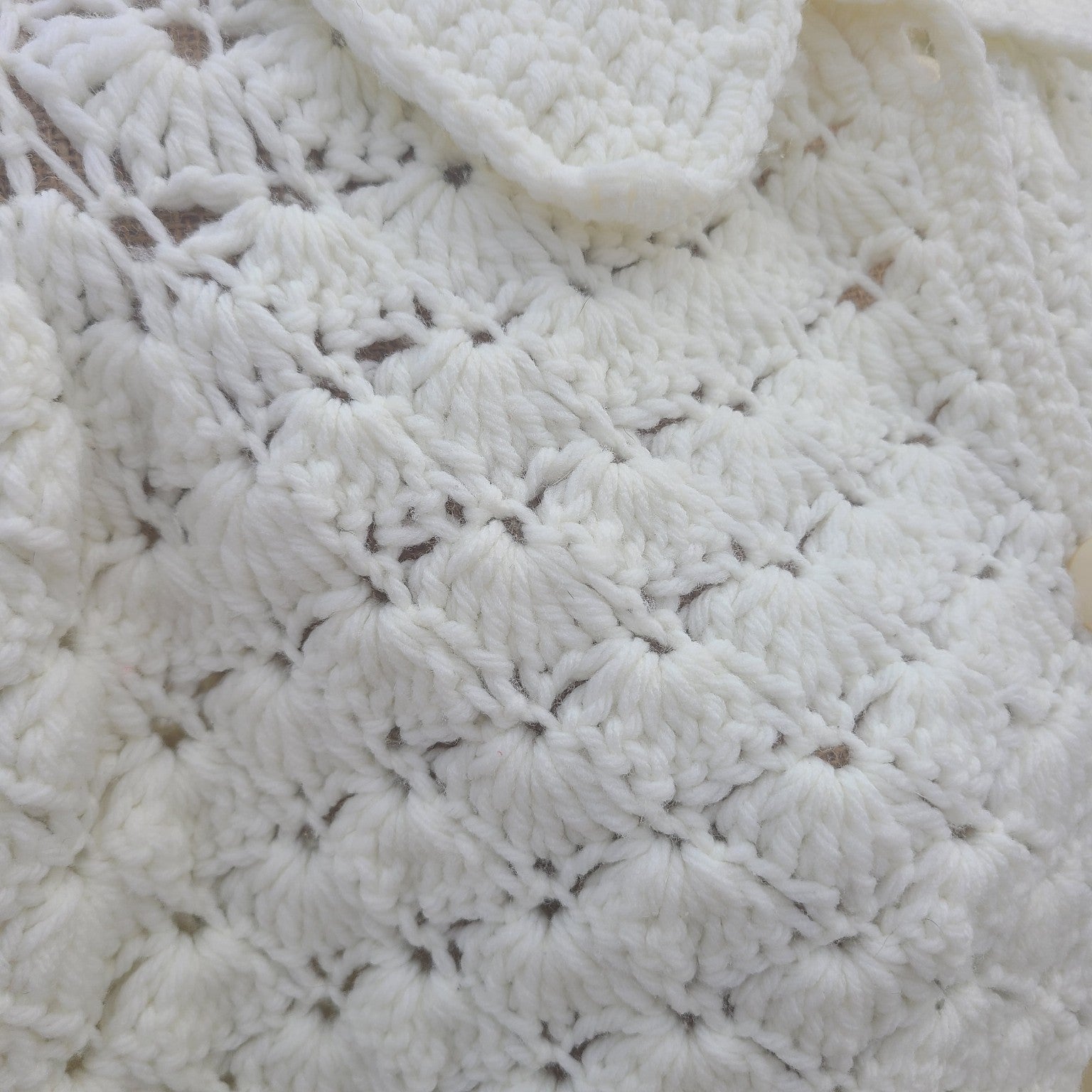 Close-up of a textured white fabric with a diamond pattern