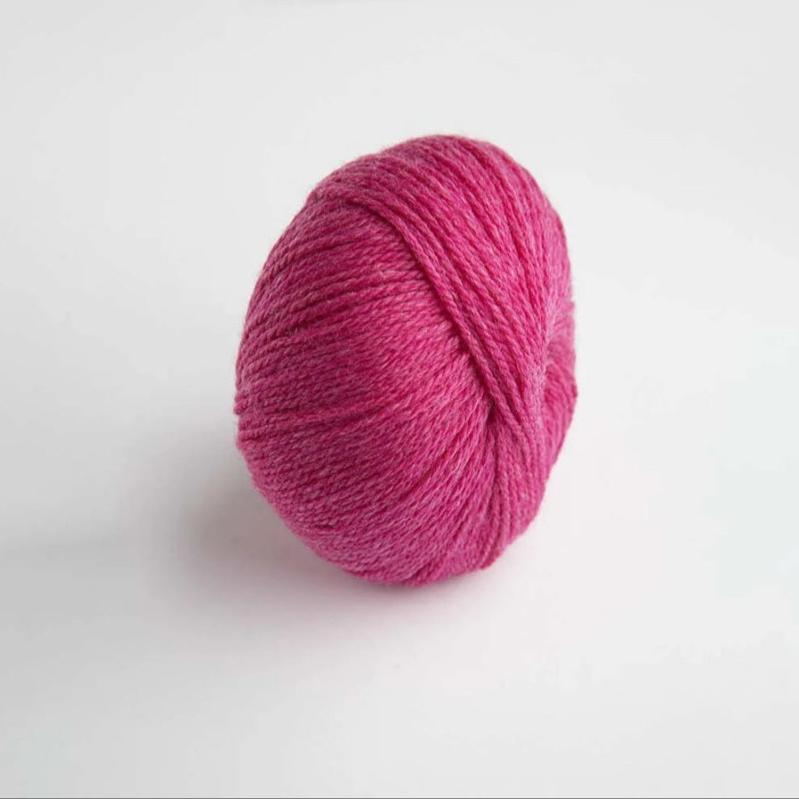Pink yarn ball on a white background