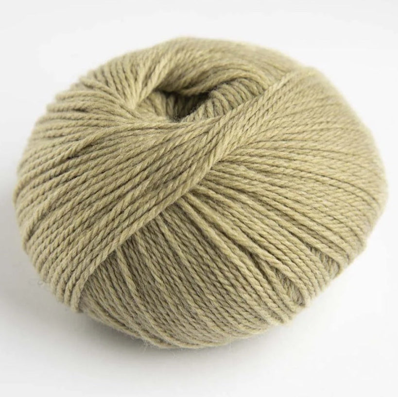 Ball of green yarn on a white background