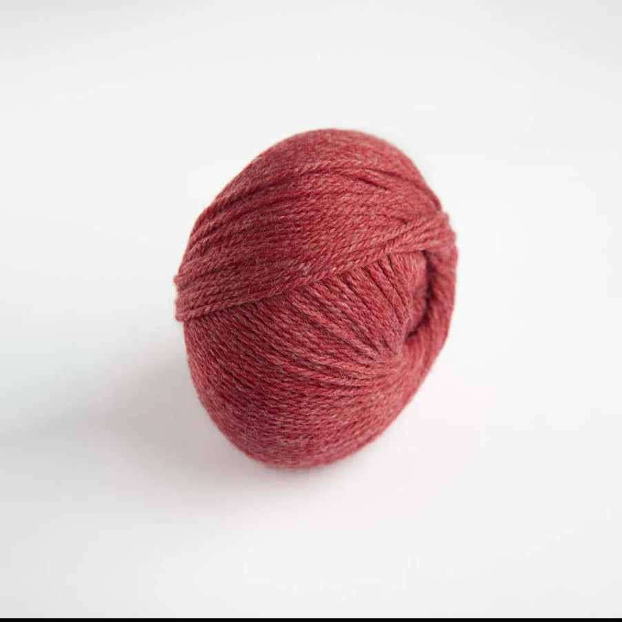 Red skein of yarn on a white background