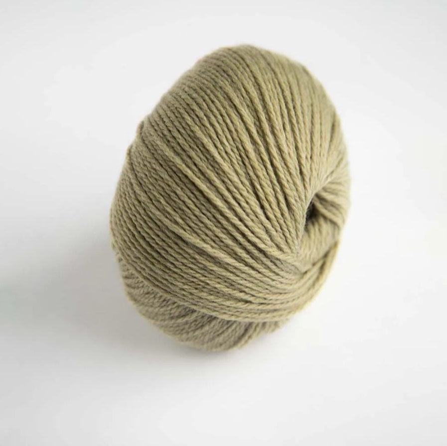 Ball of green yarn on a white background