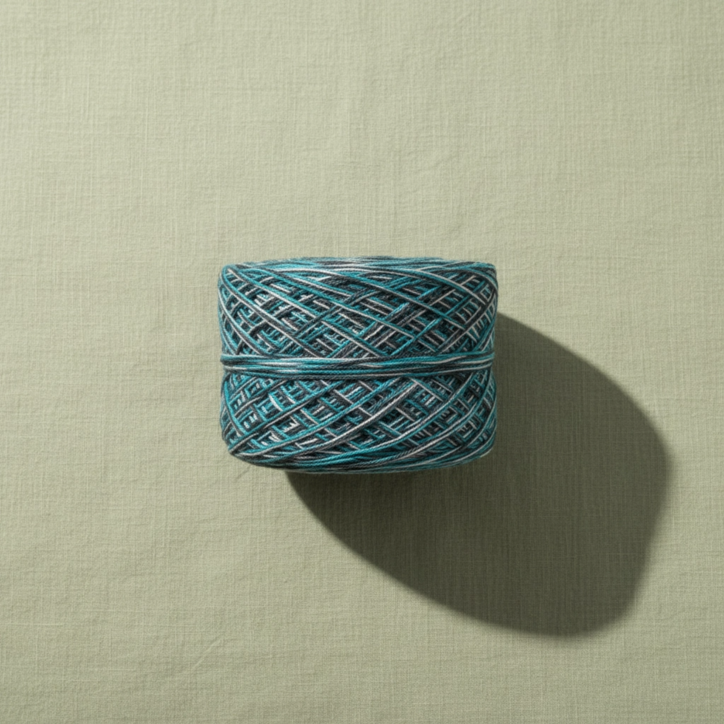Blue skein of yarn on a beige background