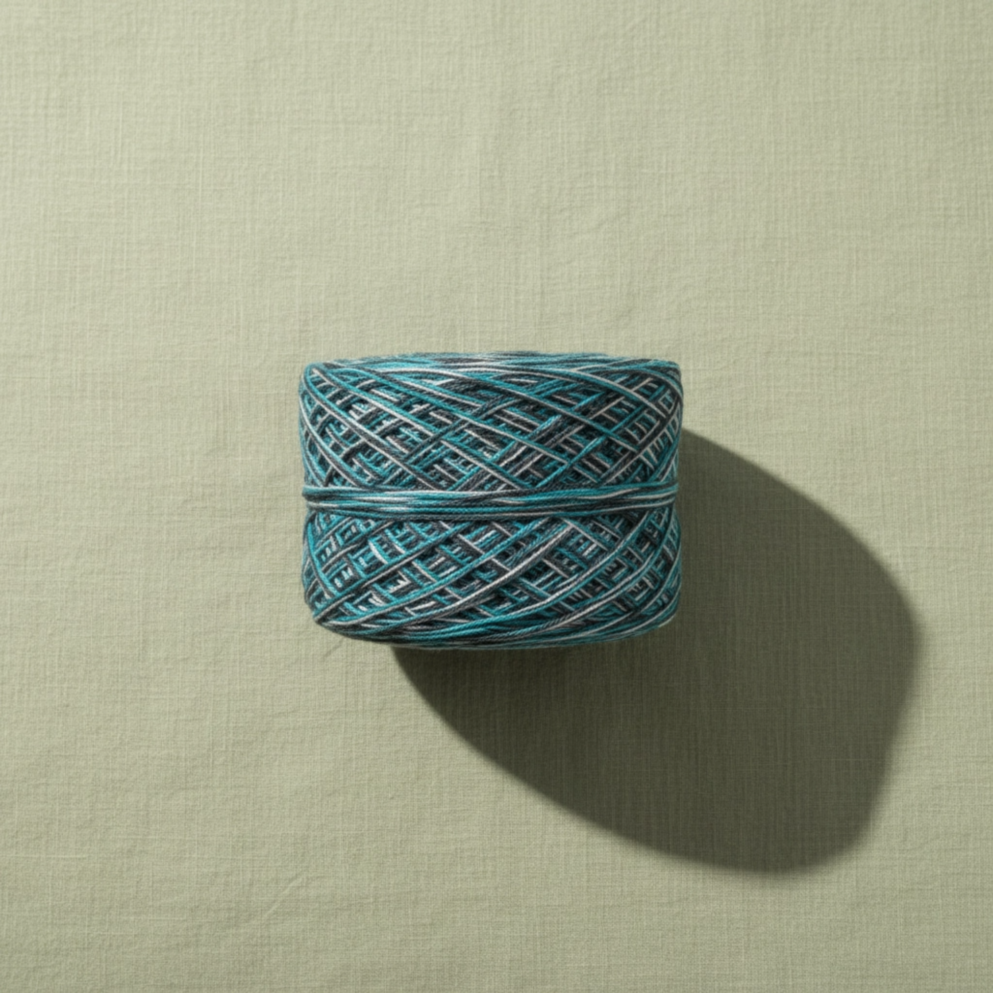 Blue skein of yarn on a beige background