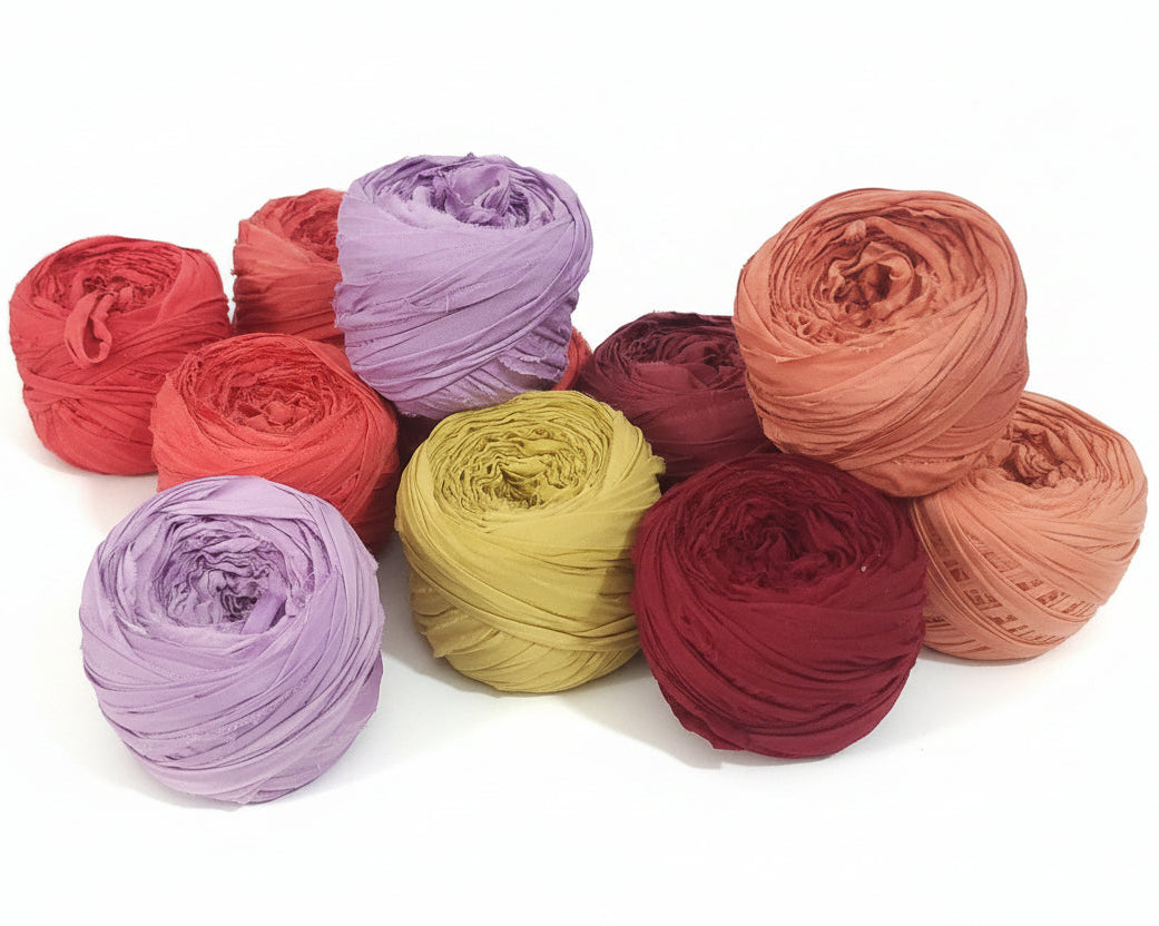 Assorted colorful yarn balls on a white background