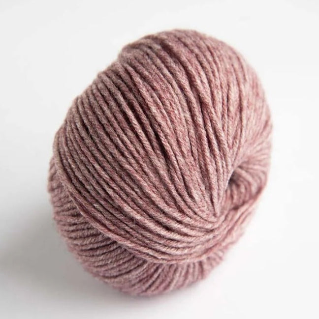 Ball of pink yarn on a white background