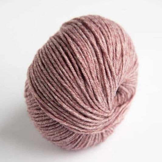 Ball of pink yarn on a white background