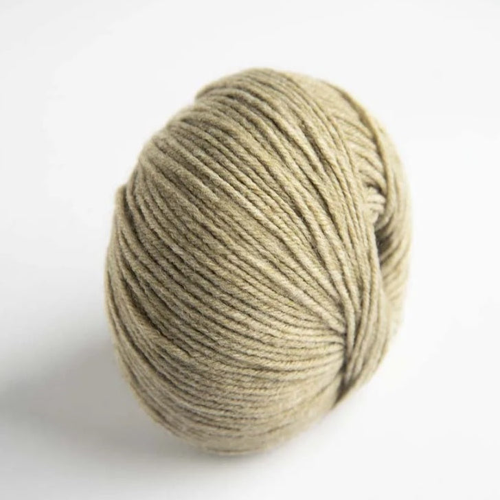 Ball of beige yarn on a white background