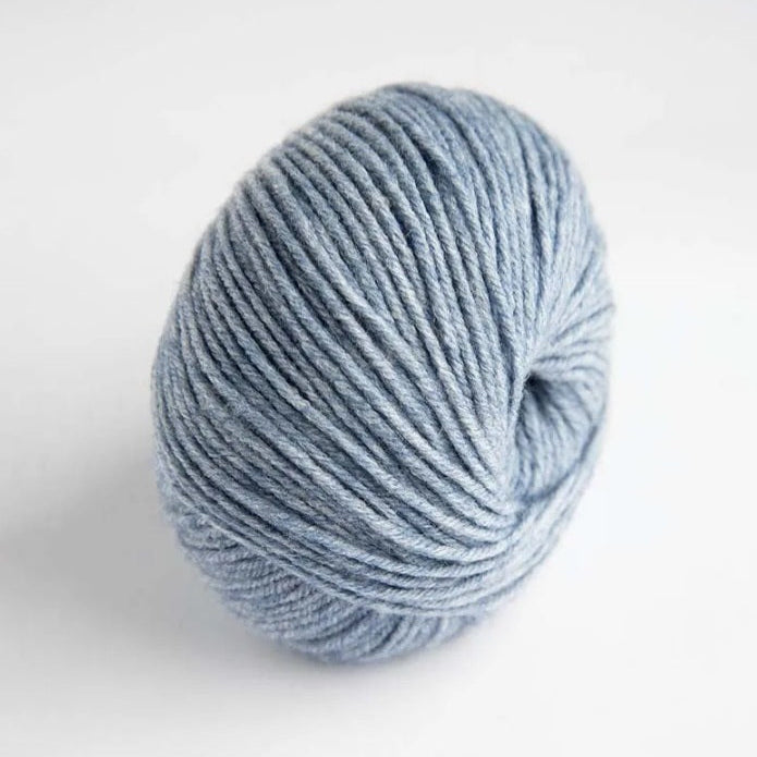 Ball of light blue yarn on a white background